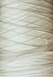 Luxury natural fabrics including linen, silk, cashmere, and fine woven textiles showcasing exceptional craftsmanship.
