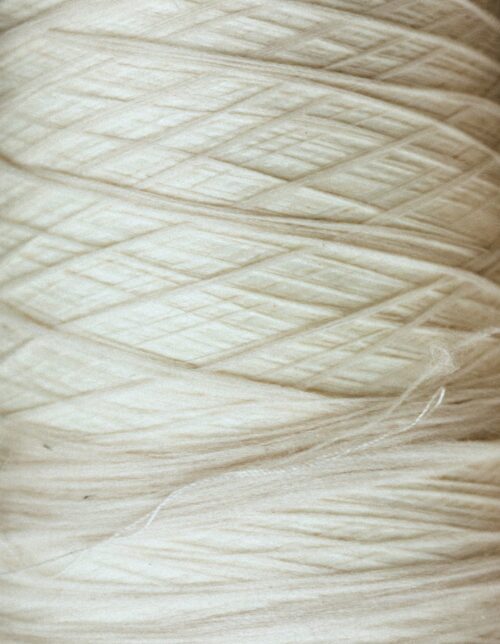Luxury natural fabrics including linen, silk, cashmere, and fine woven textiles showcasing exceptional craftsmanship.