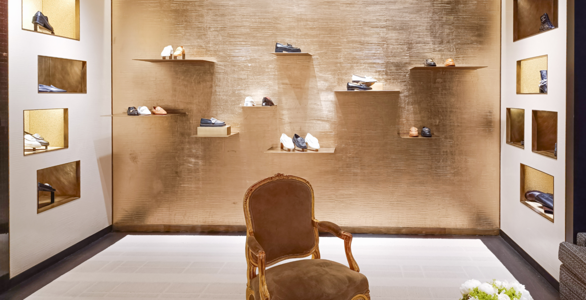 What is a Luxury fashion house boutique showcasing handcrafted leather shoes and timeless craftsmanship.